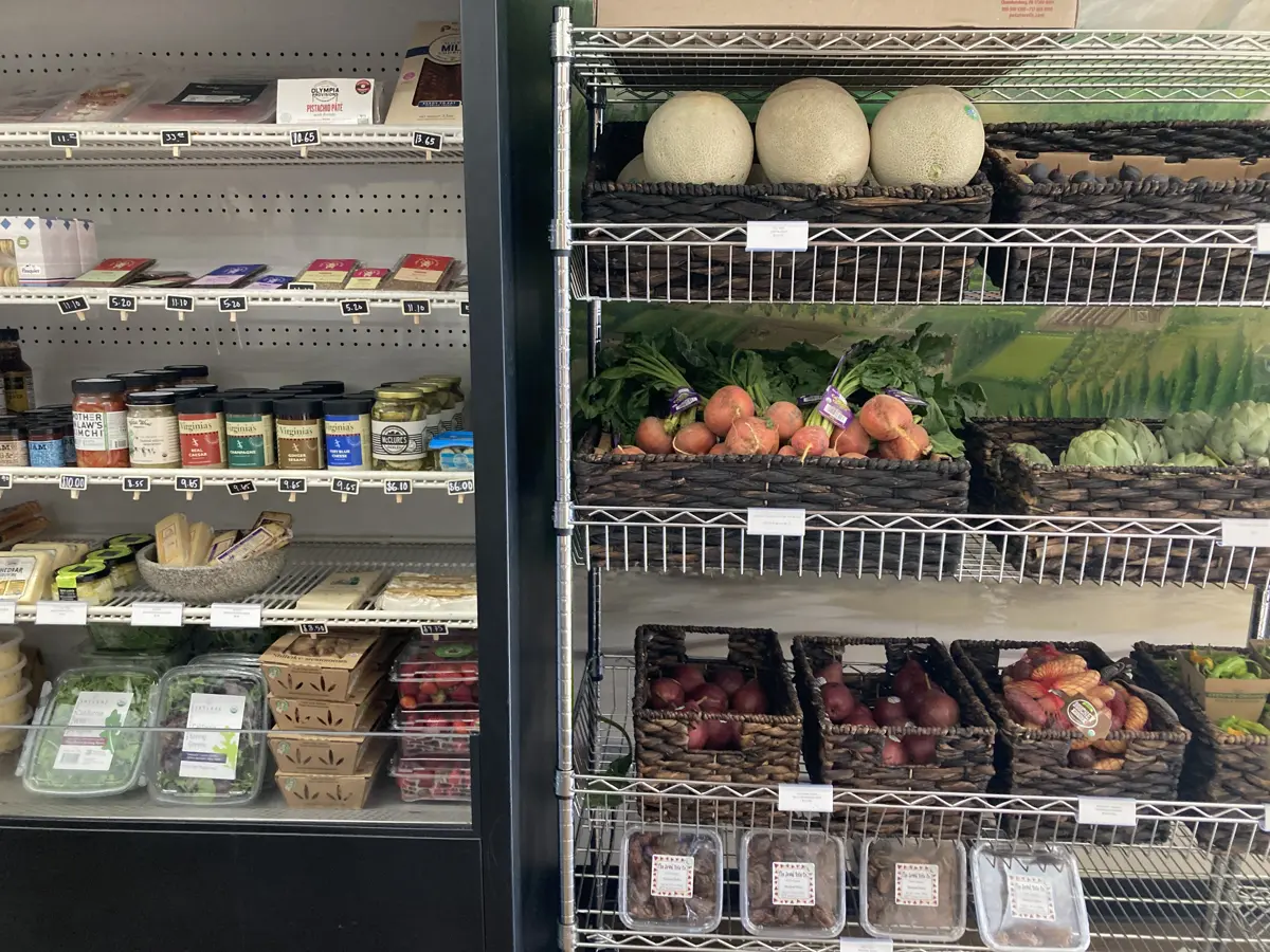 Fresh produce and refrigerated foods on display at Olympia Market